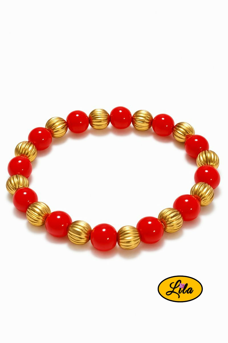 Bracelet rouge et doré sur fond blanc vue produit