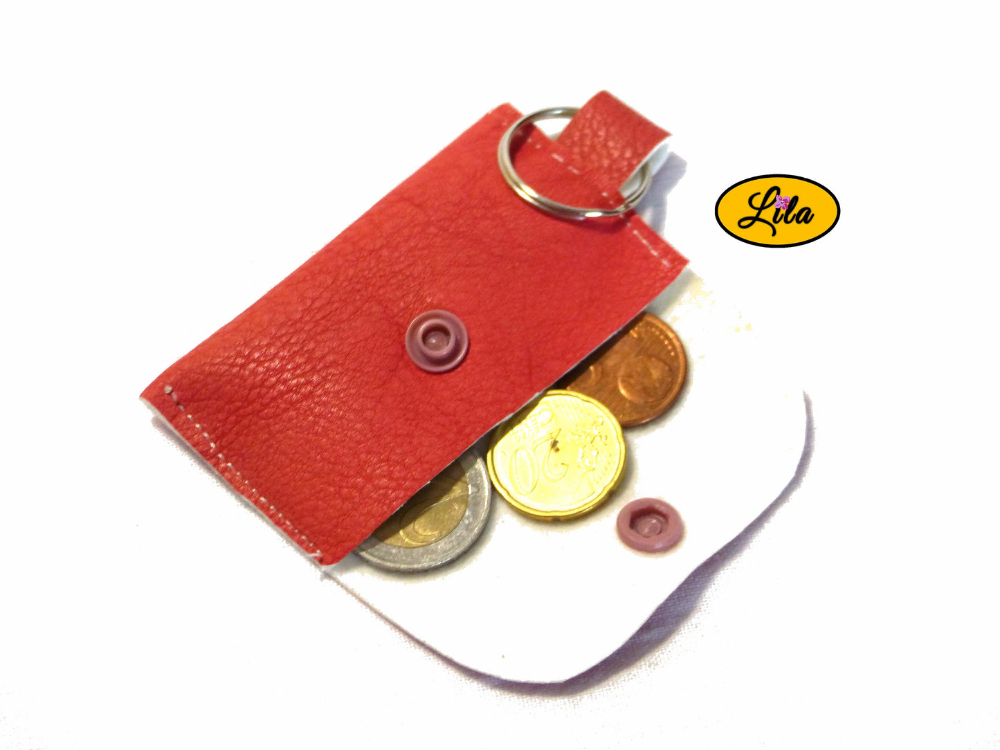 Porte-clé mini pochette rose ouverte avec pièces de monnaie