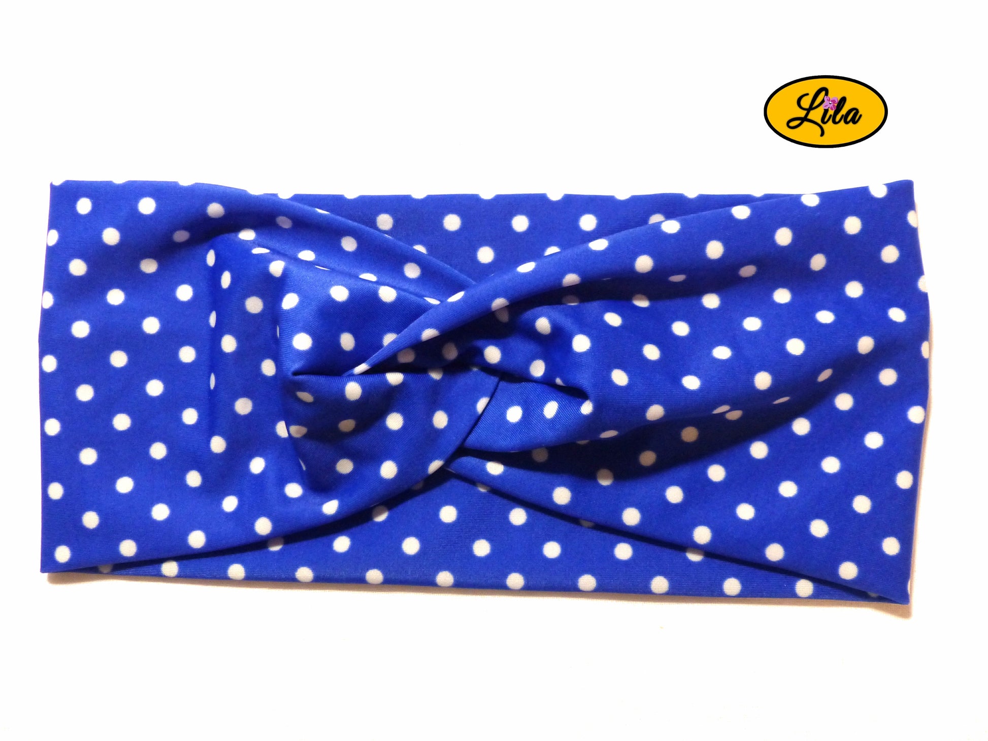 Bandeau en tissu bleu à pois blancs vu de face sur fond blanc style rétro et féminin