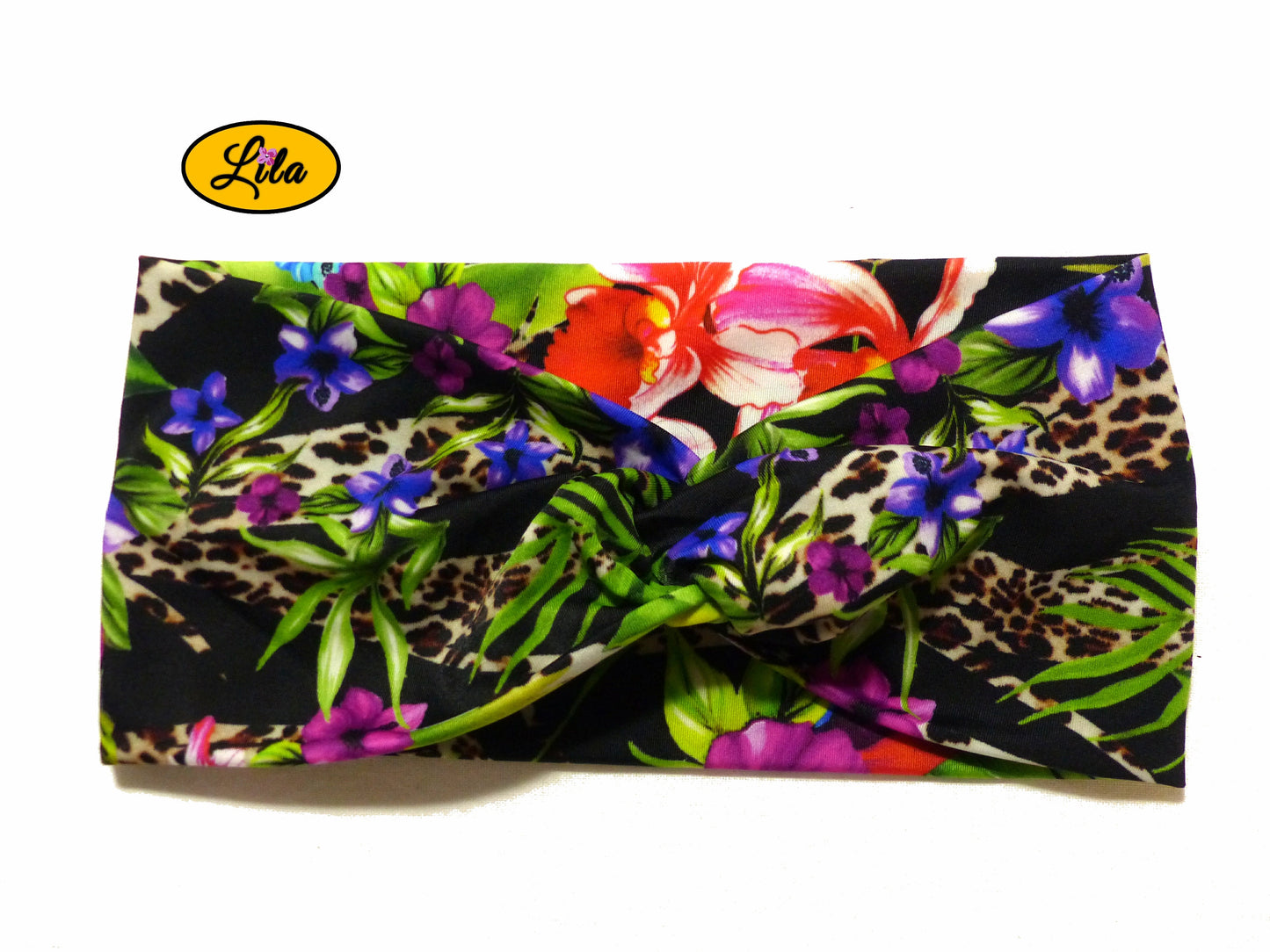 Bandeau en tissu noir à motifs de fleurs tropicales vu de face sur fond blanc style exotique et féminin