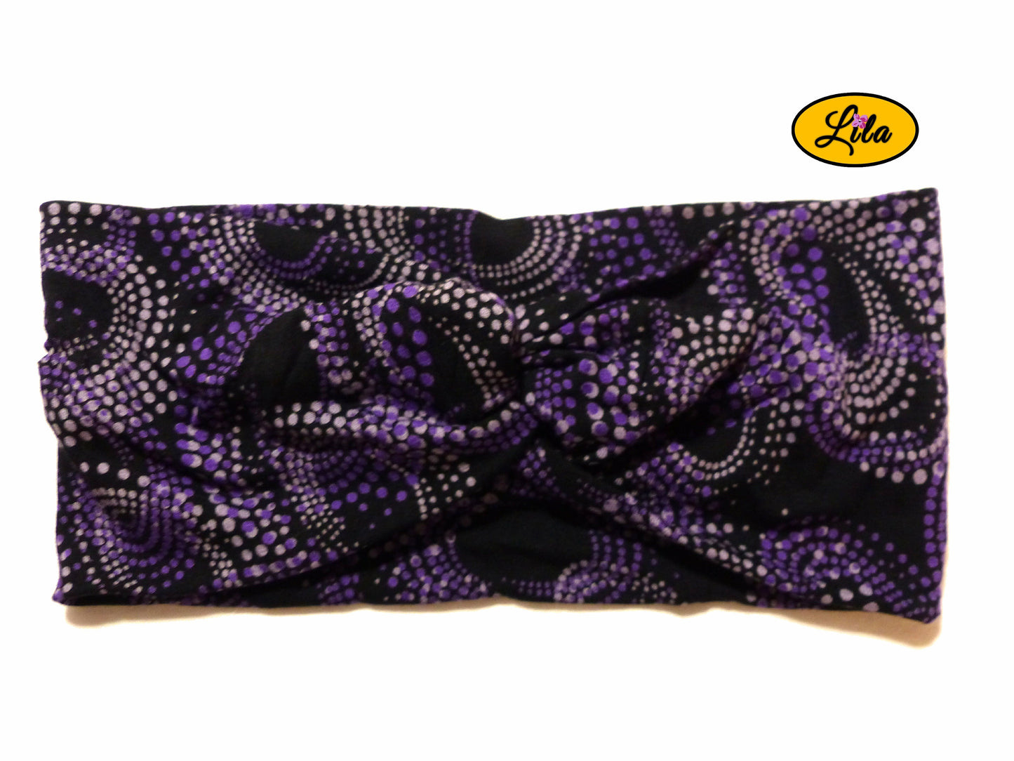 Bandeau en tissu noir à pois mauves vu de face sur fond blanc style rétro et féminin