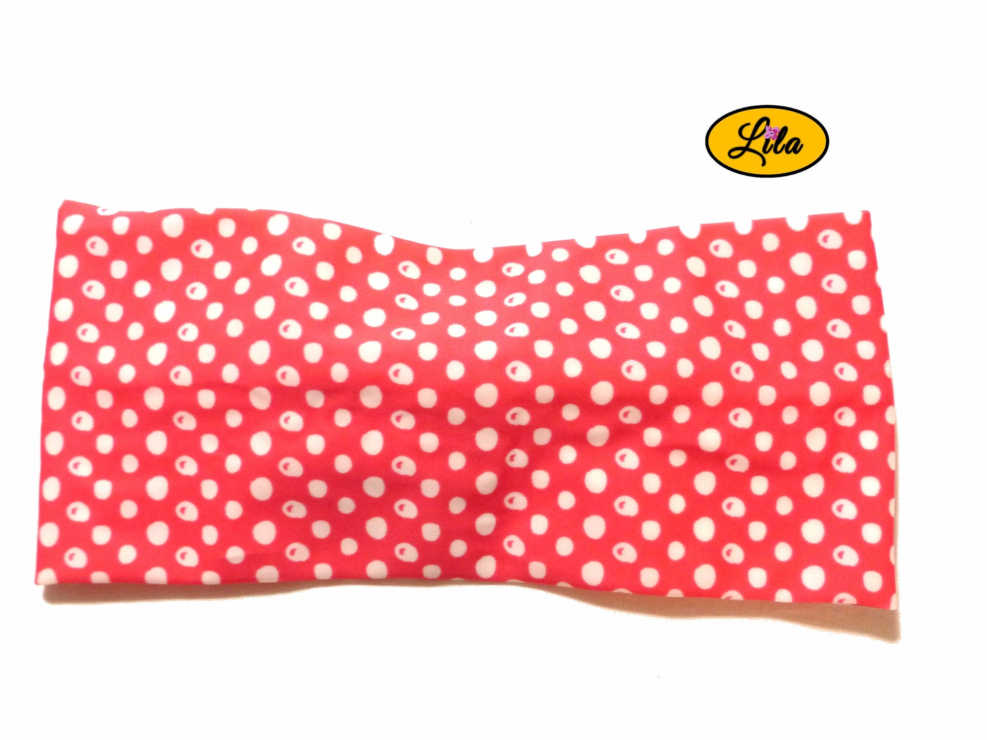 Bandeau en tissu rose à pois blancs vu de dos sur fond blanc style pin-up et tendance