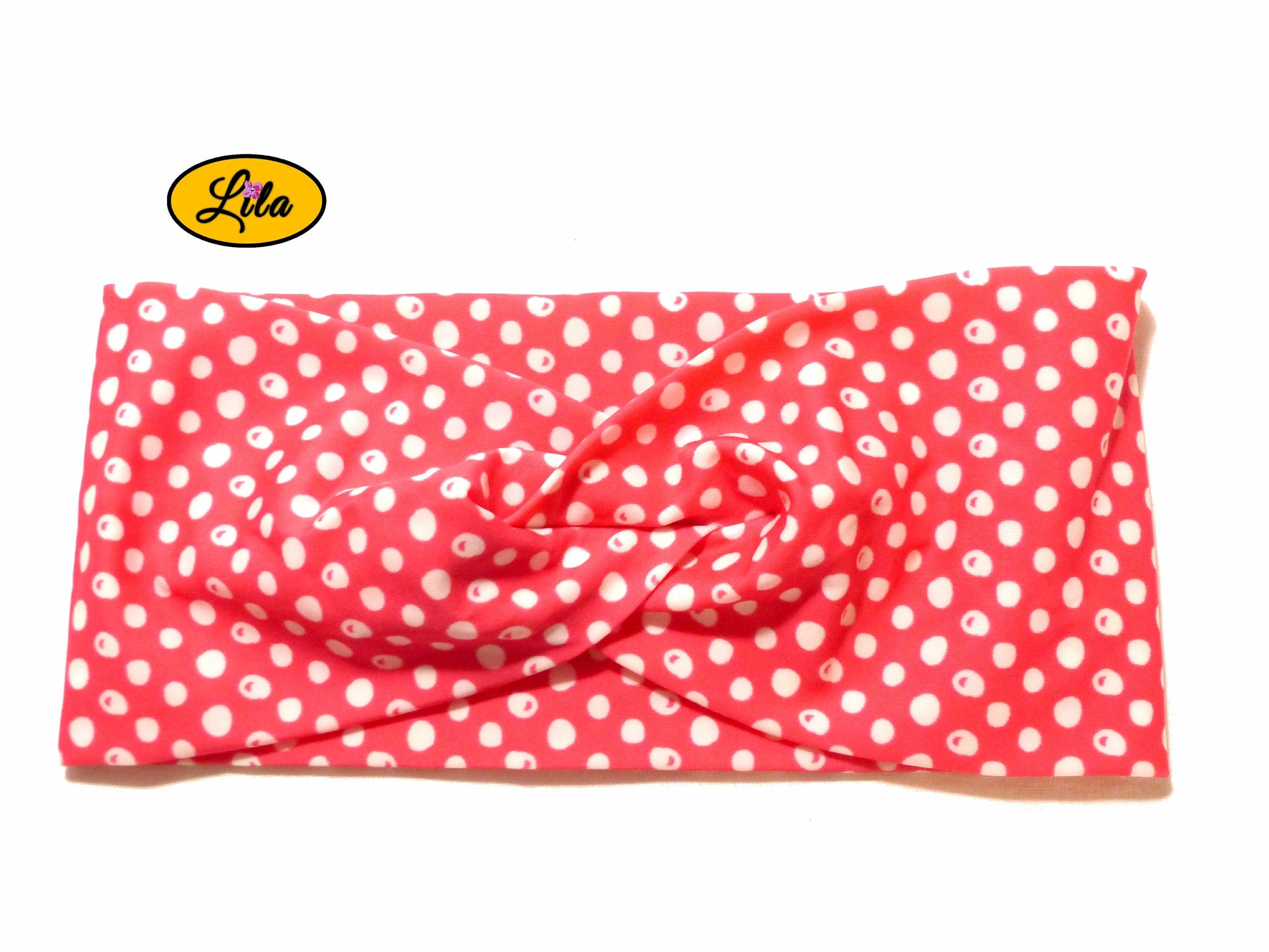 Bandeau en tissu rose à pois blancs vu de face sur fond blanc style rétro et féminin