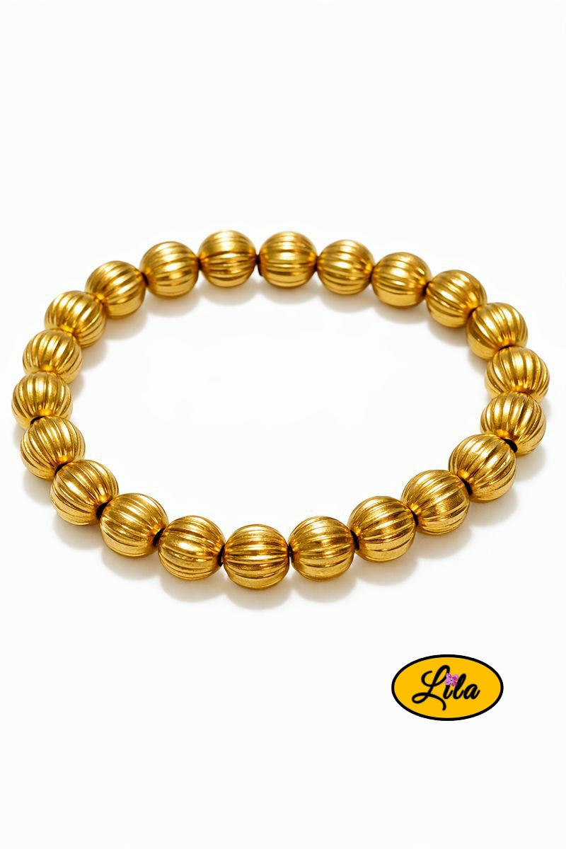 Bracelet perles rondes dorées rayées sur fond blanc vue produit