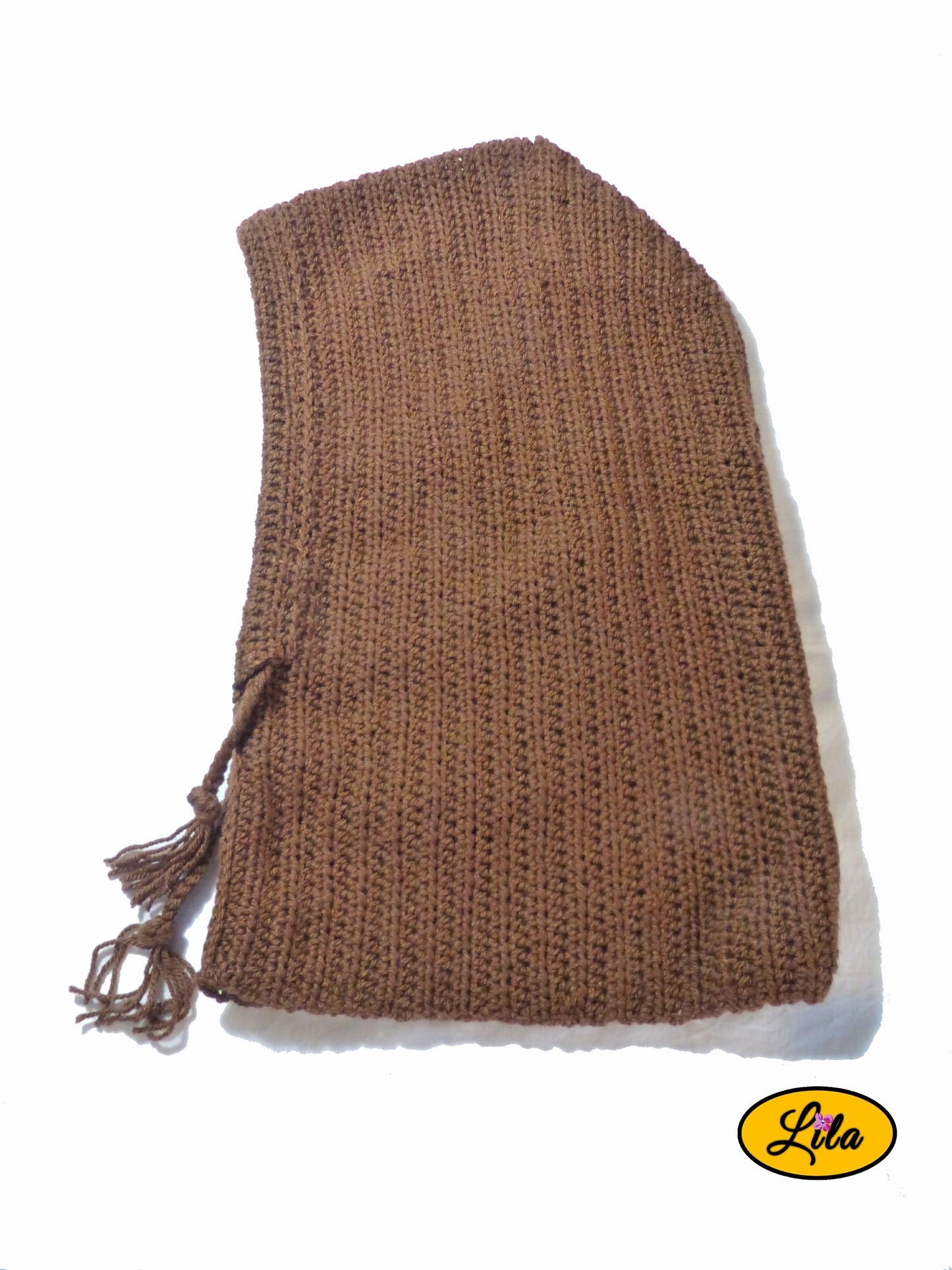 Capuche brune tricotée à la main avec cordons tressés posée à plat vue de haut tournée vers la gauche sur fond blanc style artisanal et hivernal