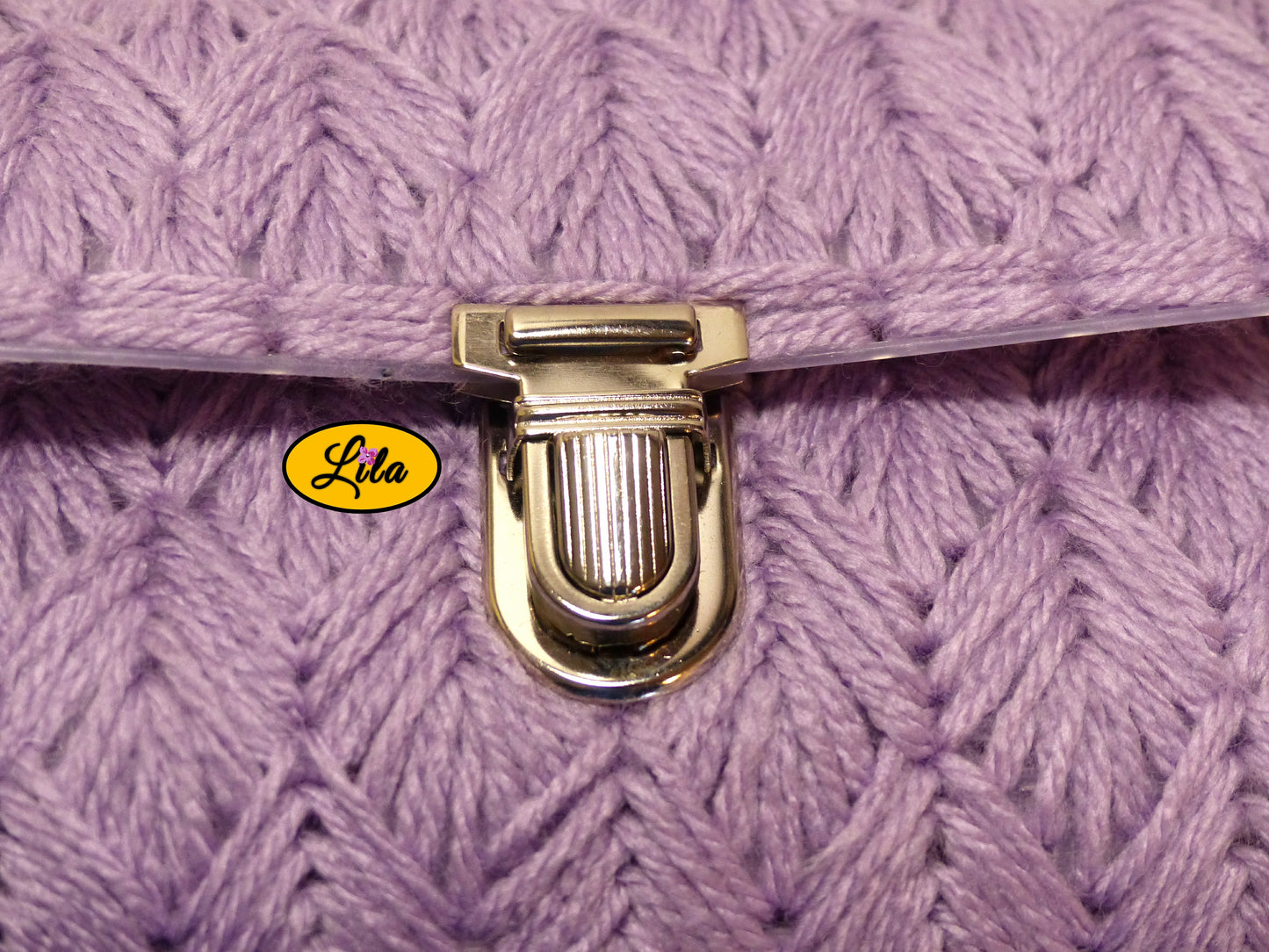 Zoom sur l’attache cartable argentée du petit sac à main aux brins lilas détail fermeture et finition métallique