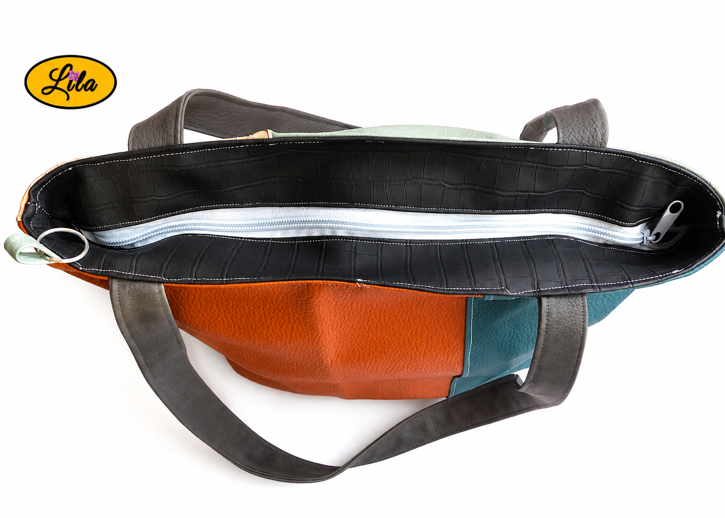 Vue de haut du sac 4 saisons en simili cuir multicolore avec fermeture éclair détail sécurité et finition