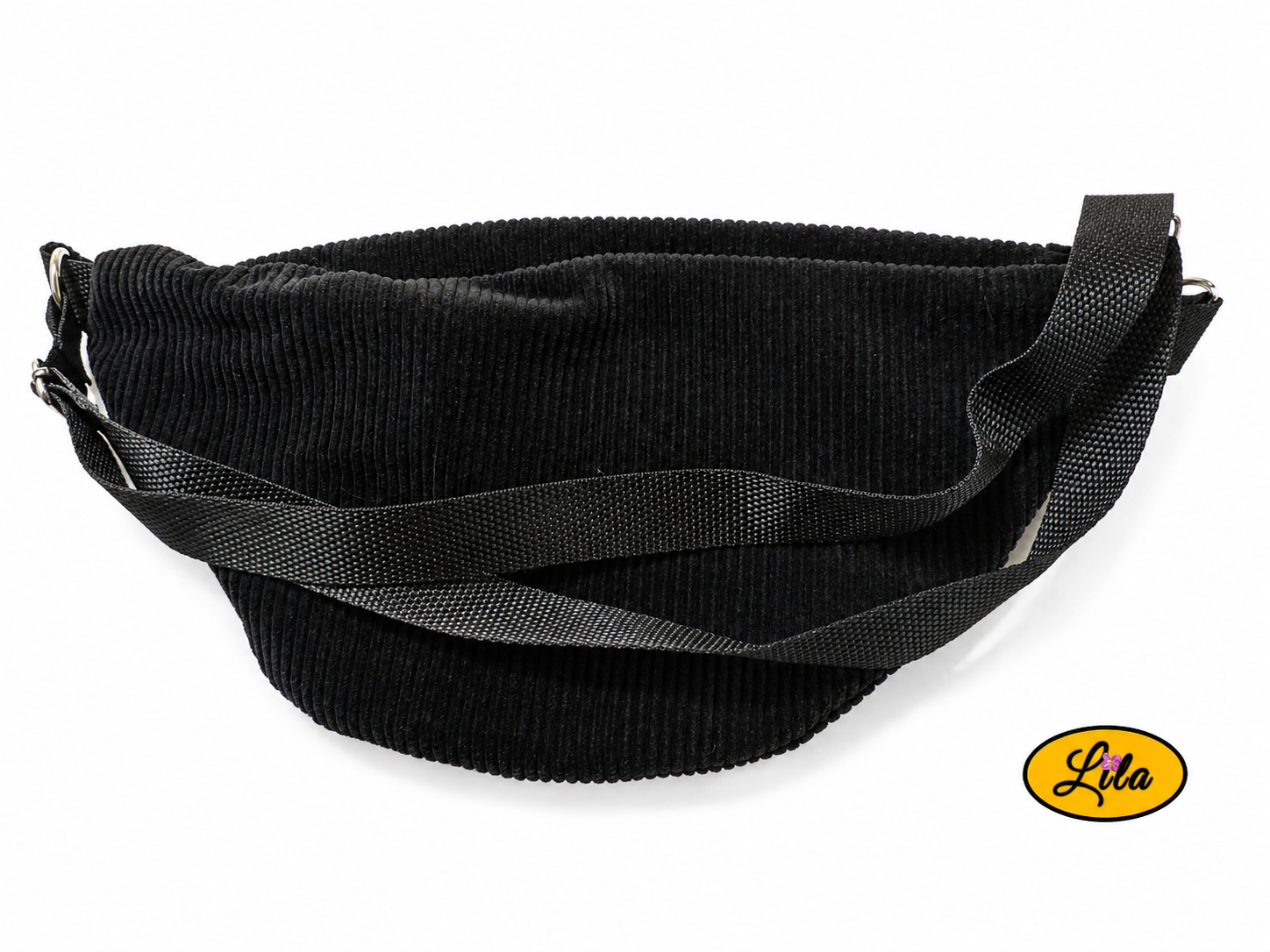 Sac banane en velours côtelé noir avec sangle noire posé à plat vue de dos sur fond blanc avec sangle visible sur le sac style minimaliste et tendance