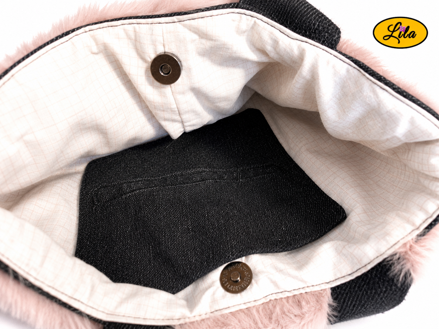 Zoom sur l’intérieur du sac à main en jeans noir et fausse fourrure vieux rose avec doublure blanche quadrillée noire, poche en jeans noir et fermeture par attache pression