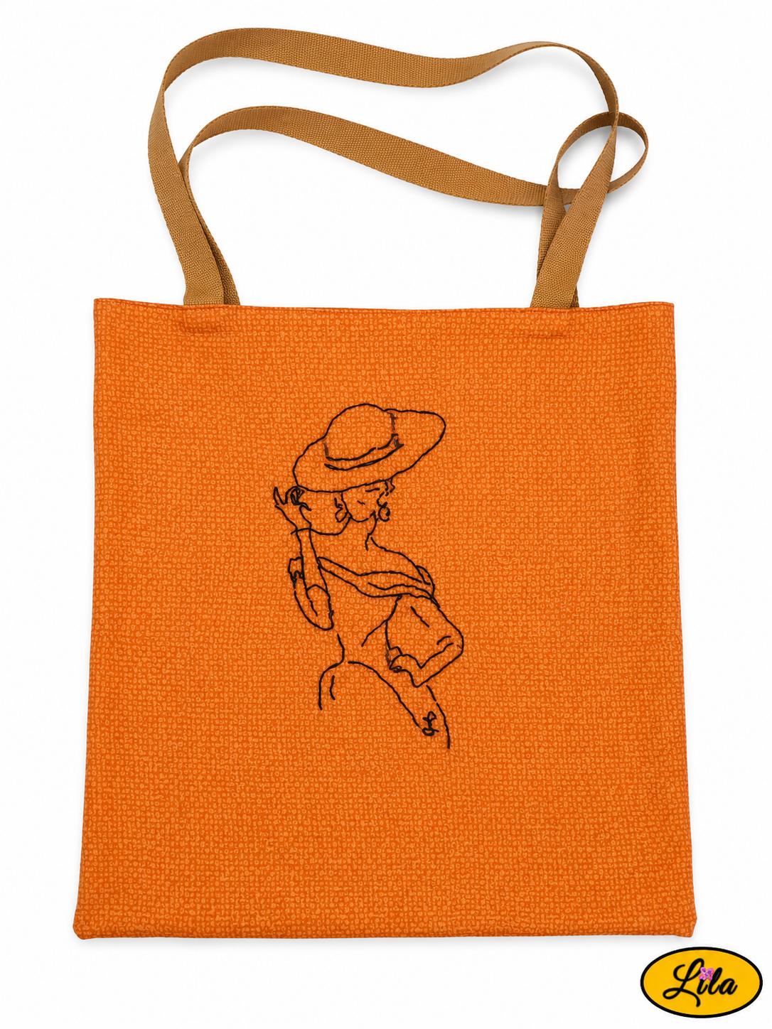 Tote bag orangé vu à plat de haut sur fond blanc avec sangles couleur sable placées au-dessus du sac et broderie représentant une mannequin vintage sur le devant style rétro et artisanal
