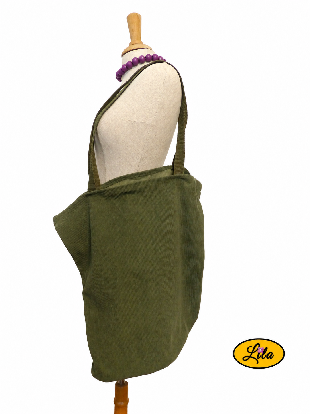 Tote bag en velours côtelé kaki porté sur mannequin de couture sur fond blanc avec sangles kaki style artisanal et tendance